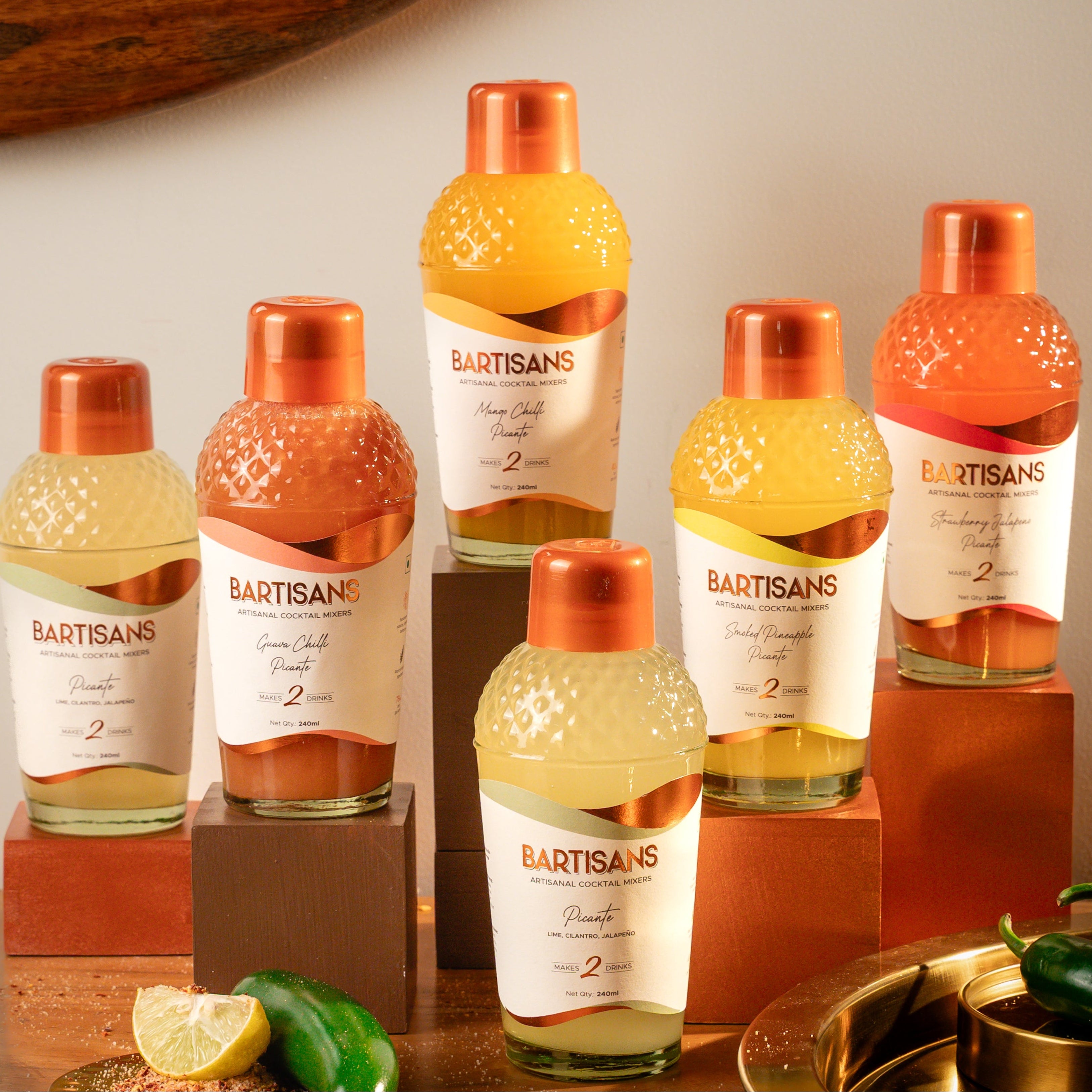 Bartisans Picante flavour bottles on a wooden surface with decorative elements