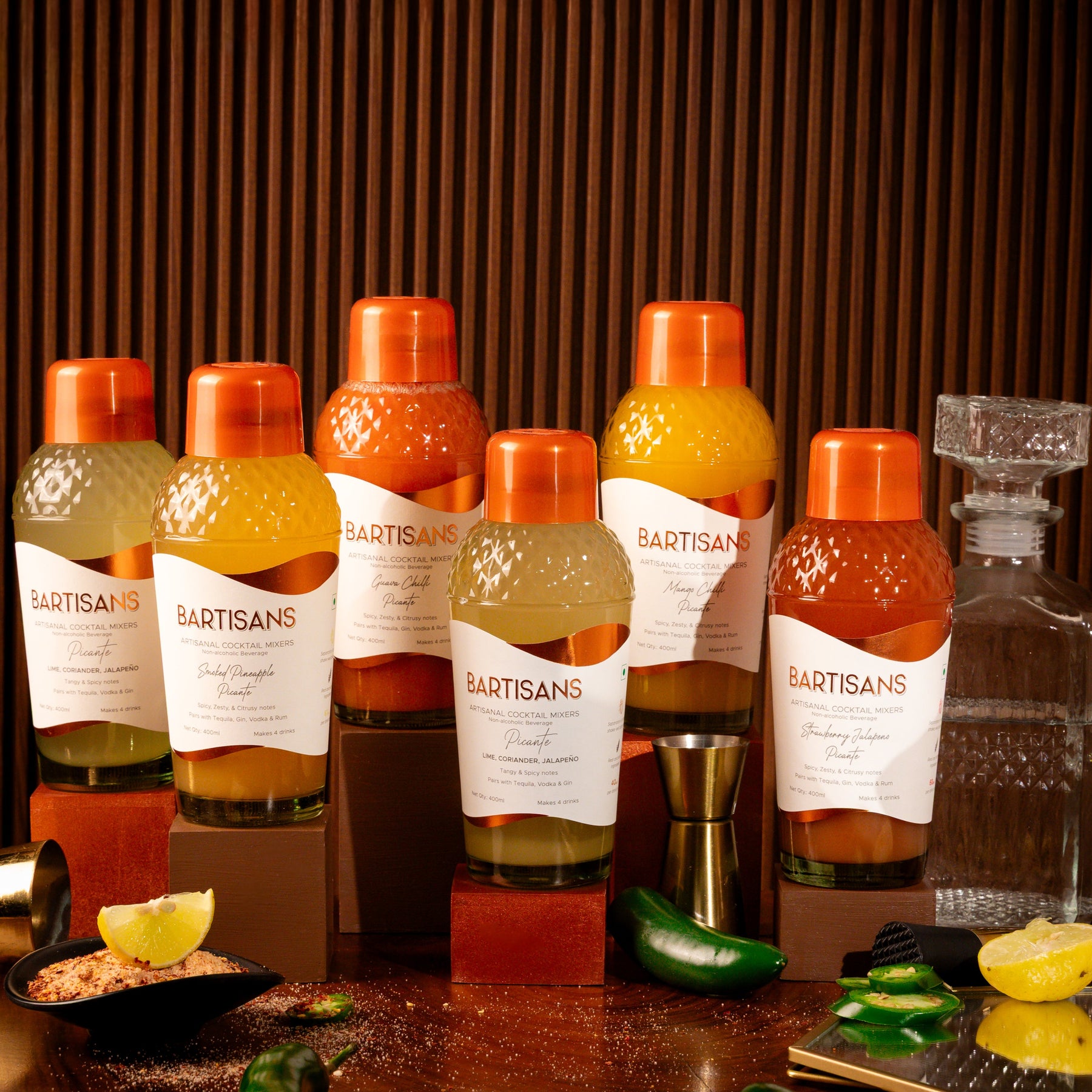 Bartisans picante flavoured bottles on a bar counter with garnishes