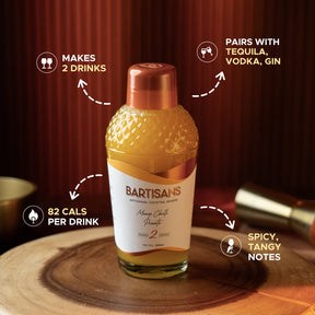 Bottle of Bartisans cocktail mixer with features highlighted on a wooden surface.