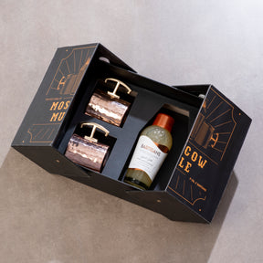 Three items in a black gift box with gold text on a gray background