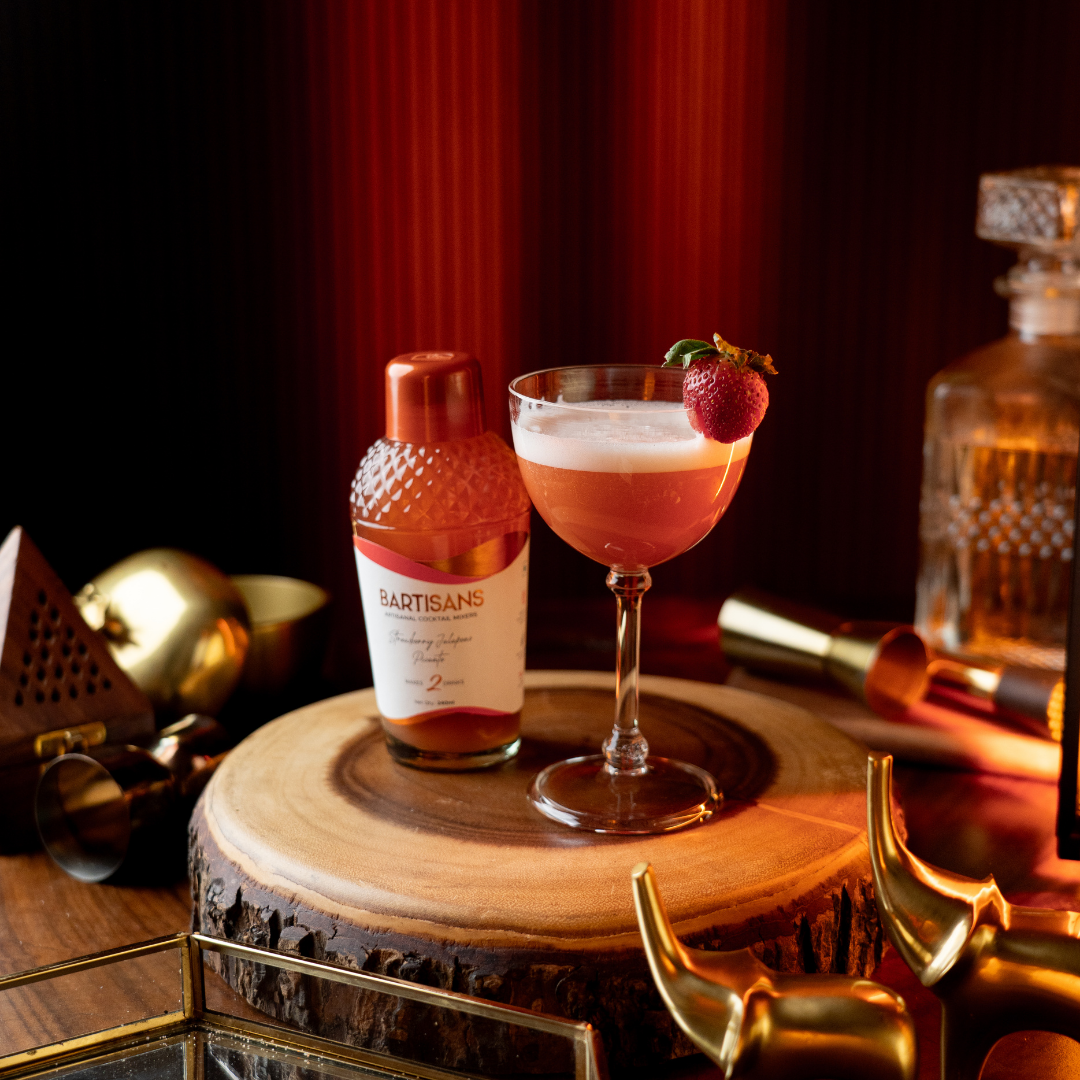  Strawberry Jalapeno Picante cocktail mixer bottle styled with a poured cocktail#Serve_2 Drinks 