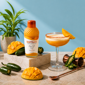 Mango Chilli Picante cocktail mixer bottle styled with a poured cocktail