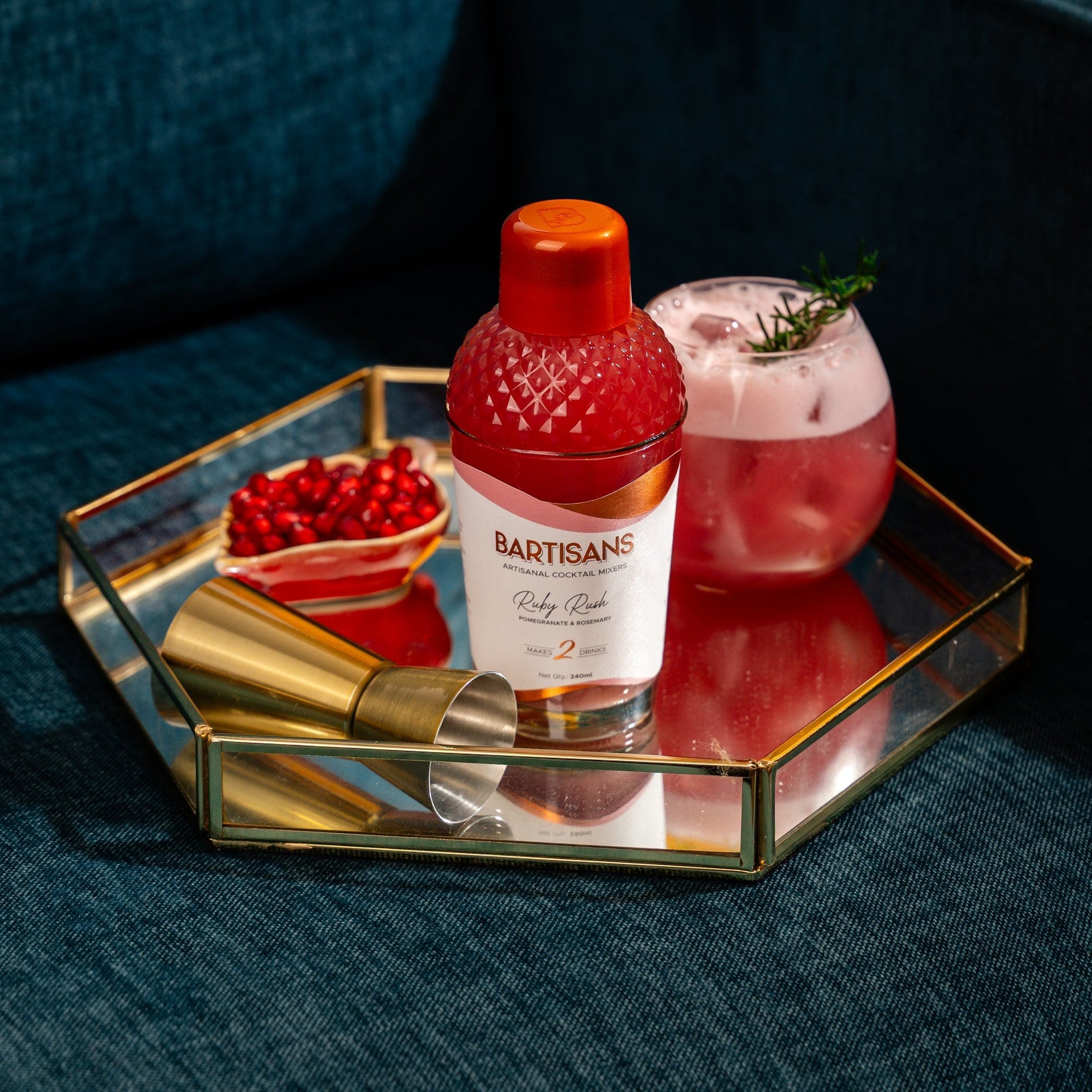  Ruby Rush cocktail mixer bottle styled with a poured cocktail#Serve_2 Drinks 